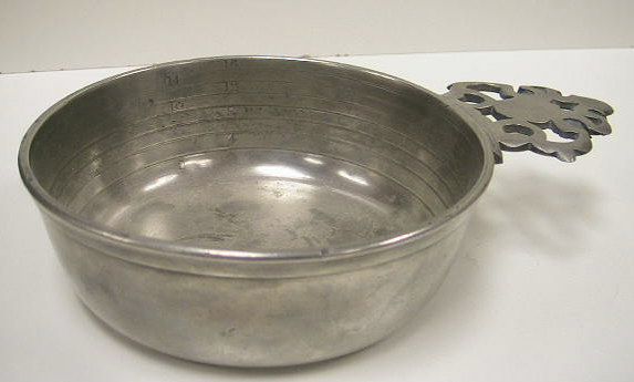 Mint condition pewter bleeding bowl.  Designed to measure the amount of b lood removed from patients.  These bowls can be differentiated from standard pewter porringers by the graduated rings and ounce markings.