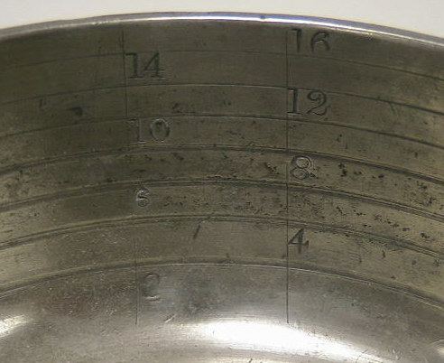 Mint condition pewter bleeding bowl.  Designed to measure the amount of b lood removed from patients.  These bowls can be differentiated from standard pewter porringers by the graduated rings and ounce markings.