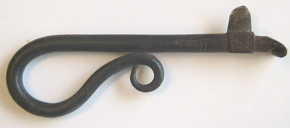 Hand forged iron fleam.  Note the serpentine finial to the handle and the beautiful cross-hatched work on the blade.  c.1650-1700