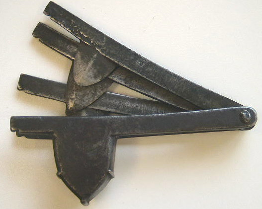 Iron folding fleam.  Very nice design to the blade basket.  c.1730-1750