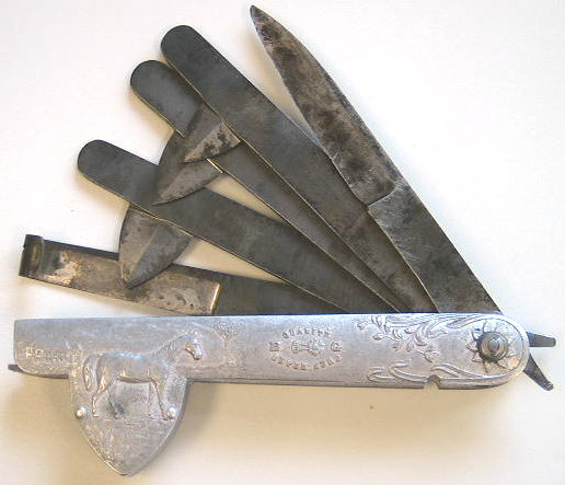Beautiful aluminum fleam marked BG as the fleam above.  Three fleam blades, one straight, one hoof knife.  French in origin c.1860-1880.  Note the beautiful scenes with the horse and cows in the field.