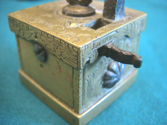 Extremely rare version of a common Viennese (Wien) brass scarificator.  This item is identical in form to the pieces seen elsewhere on the site.  The pieces all have a typical square brass construction with the heart or crown shaped depth screw and 5-6-5 blade configuration.  This piece is unique in its ornate engraving and inscription of "Joh Jacob Fischer in Wien" and the addition of a 1755 date mark.