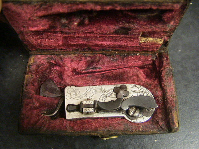 Beautiful white metal spring lancet probably Swiss in origin c. 1820-1830.  Note the beautiful floral design to the set screw holding the blade in place and the raised shell pattern to the nail-nick used to remove the back panel.  The piece is double marked Loneblad.