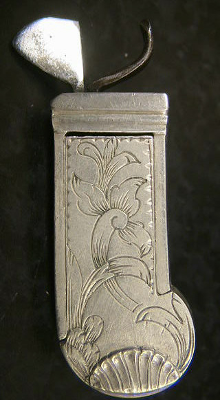 Beautiful white metal spring lancet probably Swiss in origin c. 1820-1830.  Note the beautiful floral design to the set screw holding the blade in place and the raised shell pattern to the nail-nick used to remove the back panel.  The piece is double marked Loneblad.