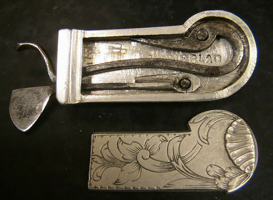 Beautiful white metal spring lancet probably Swiss in origin c. 1820-1830.  Note the beautiful floral design to the set screw holding the blade in place and the raised shell pattern to the nail-nick used to remove the back panel.  The piece is double marked Loneblad.