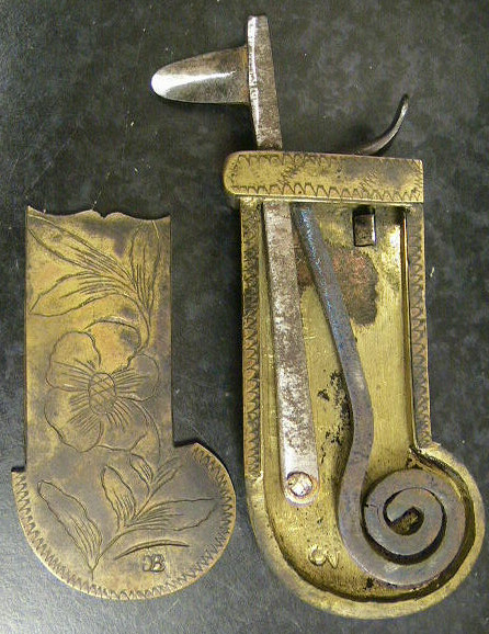 Ornately engraved brass and steel Veterinary spring lancet.  The piece has a beautifully worked release bar.  The item is marked with the makers mark: a reverge "G" and conjoined "B".  The leather case is marked with the GB on either side of what looks like a beehive.  American in origin c.1780-1800.  An identical piece can be found on the Old Sturbridge Village website.