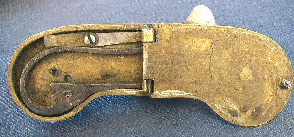 Very unusual English cased brass spring lancet with ornate floral engraving c.1800-1825.  The piece is unusual from the construction of a hinged case to allow access to the inner workings unlike the normal sliding groove design.  Another similar item in iron can be seen in the section or iron spring lancets.