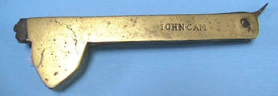 A 4 bladed brass fleam.  This piece has the typical scale style of a piece made c.1700-1750.  The scale is marked IOHN CAM, the blades are marked IHS with a cross.  This marking has heavy religious overtones as the IHS and cross mark is one emblem used by the Jesuit order, formed from the Latin spelling for Jesus, IHESUS.  Research continues into John Cam. 
