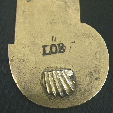 Very unusual brass cased Veterinary spring lancet.  Note that the blade retracts back behind the driver spring after firing.  The piece is decorated with a nice shell on the end of the release mechanism and on the back plate.  It is marked wiht the makers mark LOB.  Probably German in origin c.1800-1825.