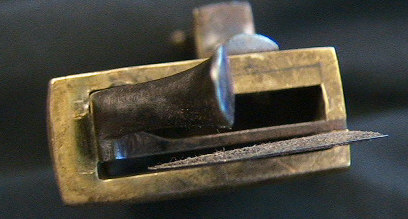 Very unusual brass cased Veterinary spring lancet.  Note that the blade retracts back behind the driver spring after firing.  The piece is decorated with a nice shell on the end of the release mechanism and on the back plate.  It is marked wiht the makers mark LOB.  Probably German in origin c.1800-1825.