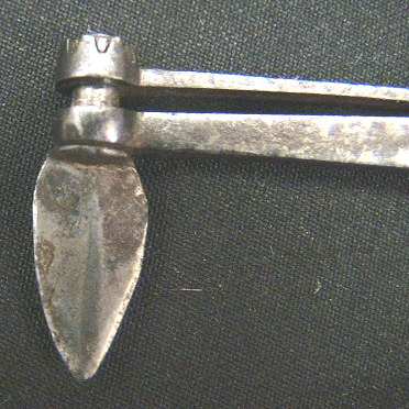 Small folding fleam with horn scales.  The item is marked Hunt Boston.  This very diminutive tool has a spring steel loaded back that allows you to drop the retaining cuff down and rotate the blade 360 degrees.  I am not certain this item had any use in the bloodletting field, it may very possibly be a gum lancet based on the size and the versatility of blade direction.