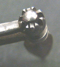 Small folding fleam with horn scales.  The item is marked Hunt Boston.  This very diminutive tool has a spring steel loaded back that allows you to drop the retaining cuff down and rotate the blade 360 degrees.  I am not certain this item had any use in the bloodletting field, it may very possibly be a gum lancet based on the size and the versatility of blade direction.